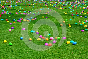 An Easter egg hunt with plastic eggs on a green lawn