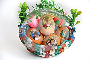 An Easter egg with an imageEaster eggs in basket on white background