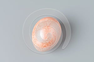 An Easter egg painted like marble on a grey background. Easter eggs background. Easter eggs are a symbol and a mandatory attribute