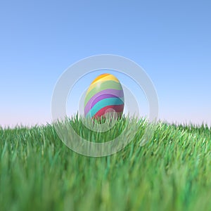 Easter Egg Rainbow colored on green grass hill