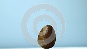 Easter egg revolving on blue background