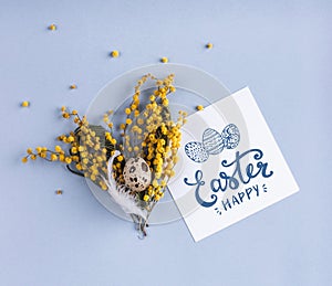 Easter egg and spring flowers on holiday background with Easter card.