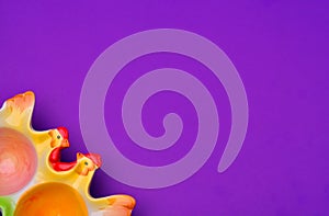 Easter egg stand in the form of chicken on a purple background