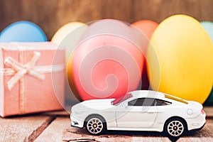 Easter egg and toy car on wooden background