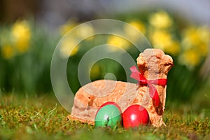 Easter eggs and a baked Easter lamb in a meadow