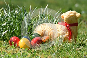 Easter eggs and a baked Easter lamb in a meadow photo