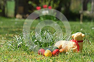 Easter eggs and a baked Easter lamb in a meadow photo