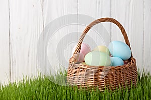 Easter eggs basket in grass meadow