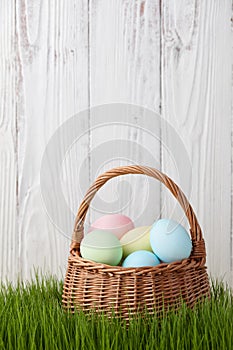 Easter eggs basket in grass meadow