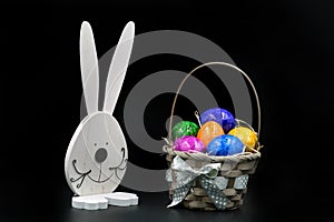 Easter Eggs in Basket with rabbit on black background