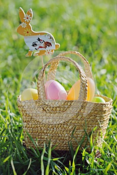 Easter eggs in a basket with rabbit decorations