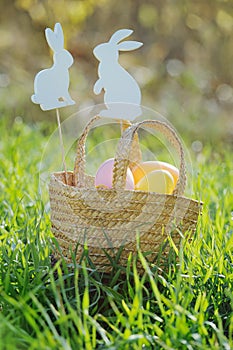 Easter eggs in a basket with rabbit decorations