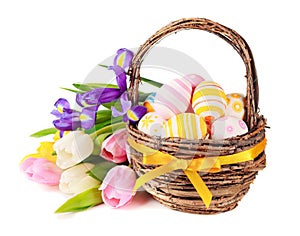 Easter eggs in a basket and spring flowers