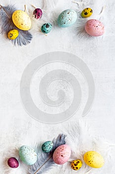 Easter eggs with birds feather. Decoration concept, top view
