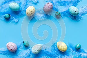 Easter eggs with birds feather. Decoration concept, top view