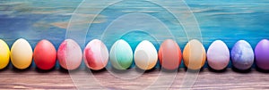 Easter eggs on blue wooden background. Wide banner