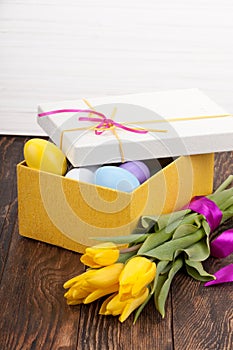 Easter Eggs in a box with colorful tulips