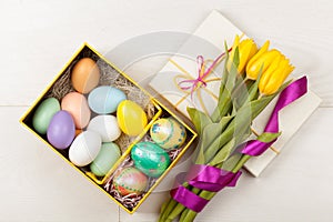 Easter Eggs in a box with colorful tulips