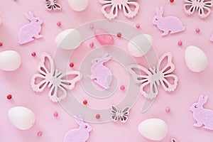 Easter eggs butterflies confetti on pink background monochromeon. Top view. Happy Easter concept. Flat lay