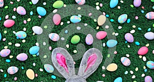 Easter eggs and candy with pink bunny ears