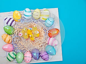 Easter eggs and chiks on blue background