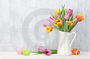 Easter eggs and colorful tulips bouquet