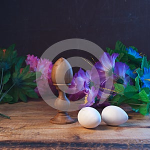 Easter eggs in composition with flowers in rustic style,
