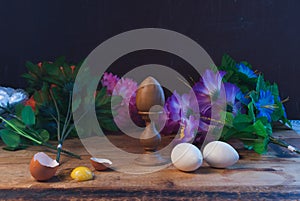 Easter eggs in composition with flowers in rustic style,