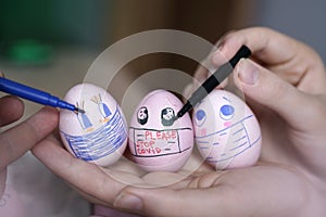 Easter eggs with Corona virus protection concepts. DIY easter eggs wearing mask for Easter holidays decoration. Selective