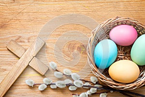 Easter eggs and cross on abstract wooden spring background