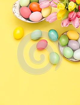 Easter eggs decoration spring tulip flowers yellow background