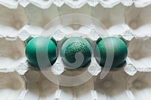 Easter eggs of different colors in tray