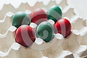 Easter eggs of different colors in tray
