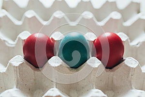 Easter eggs of different colors in tray