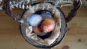 Easter eggs with dry flowers into the basket