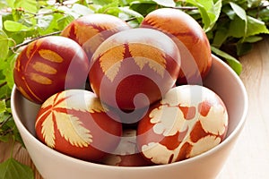 Easter eggs dyed with onion peels, with a pattern of fresh herbs