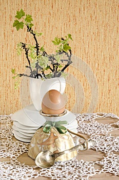 Easter eggs in eggcups with gold spoons