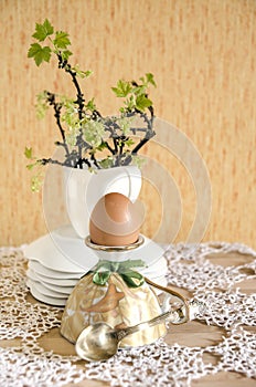 Easter eggs in eggcups with gold spoons