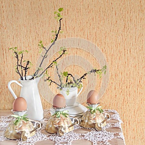 Easter eggs in eggcups with gold spoons