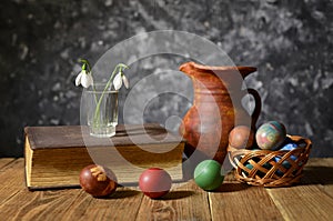Easter eggs, flowers and ceramic carafe