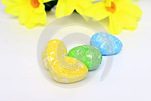 Easter eggs among flowers. The concept of celebrating Easter