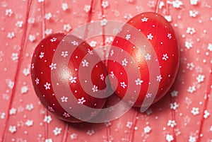 Easter eggs on flowery pattern