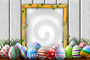 Easter eggs in the garden with blank frame