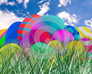 Easter Eggs in Grass with Blue Sky Background