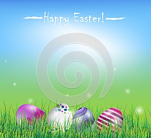 Easter eggs in the grass on spring background