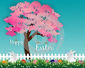 Easter eggs on green grass in the garden with white rabbits,little daisy and butterfly under sakura tree on soft blue background