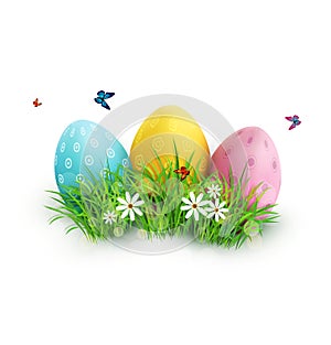 Easter eggs in green grass with white flowers