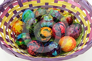 Easter eggs. Handmade painted eggs in basket for Easter celebration isolated on white background. Easter. Colored Easter eggs