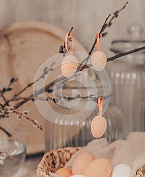 Easter eggs hanging from pussy willow branches, rustic style