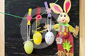 Easter eggs hanging from a string and a bunny